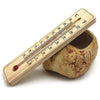 Wooden thermometer on pottery with red liquid indicator