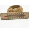 Wooden thermometer with red liquid indicator on pottery