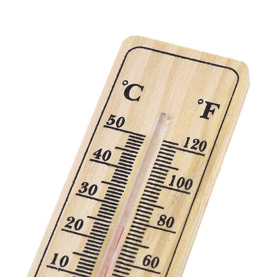 Top section of wooden thermometer showing temperature scales