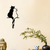 Black metal cat wall art with plant and Buddha statue