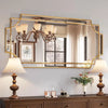 Elegant wall mirror with gold frame above dresser