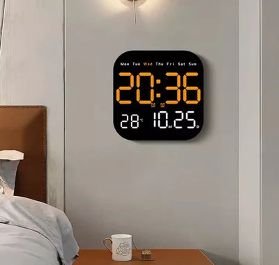 Orange LED wall clock in bedroom with time and temperature