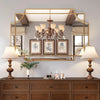 Large decorative mirror reflecting chandelier