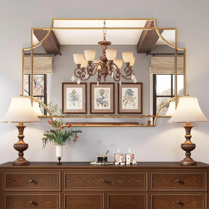 Elegant wall mirror with gold frame above dresser