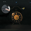 Retro twin bell alarm clock glowing at night