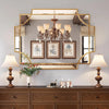 Large decorative mirror reflecting chandelier