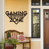 Gaming Zone metal wall decor on yellow house exterior