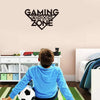 Child in blue shirt with Gaming Zone wall sign in playroom