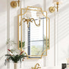 Elegant wall mirror with gold frame above dresser