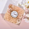 Square resin clock with pink floral design.