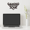 Gaming Zone wall decor above laptop on white desk